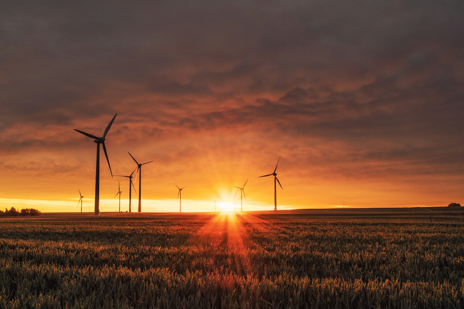 Wind turbines silhouetted against a dramatic sunset